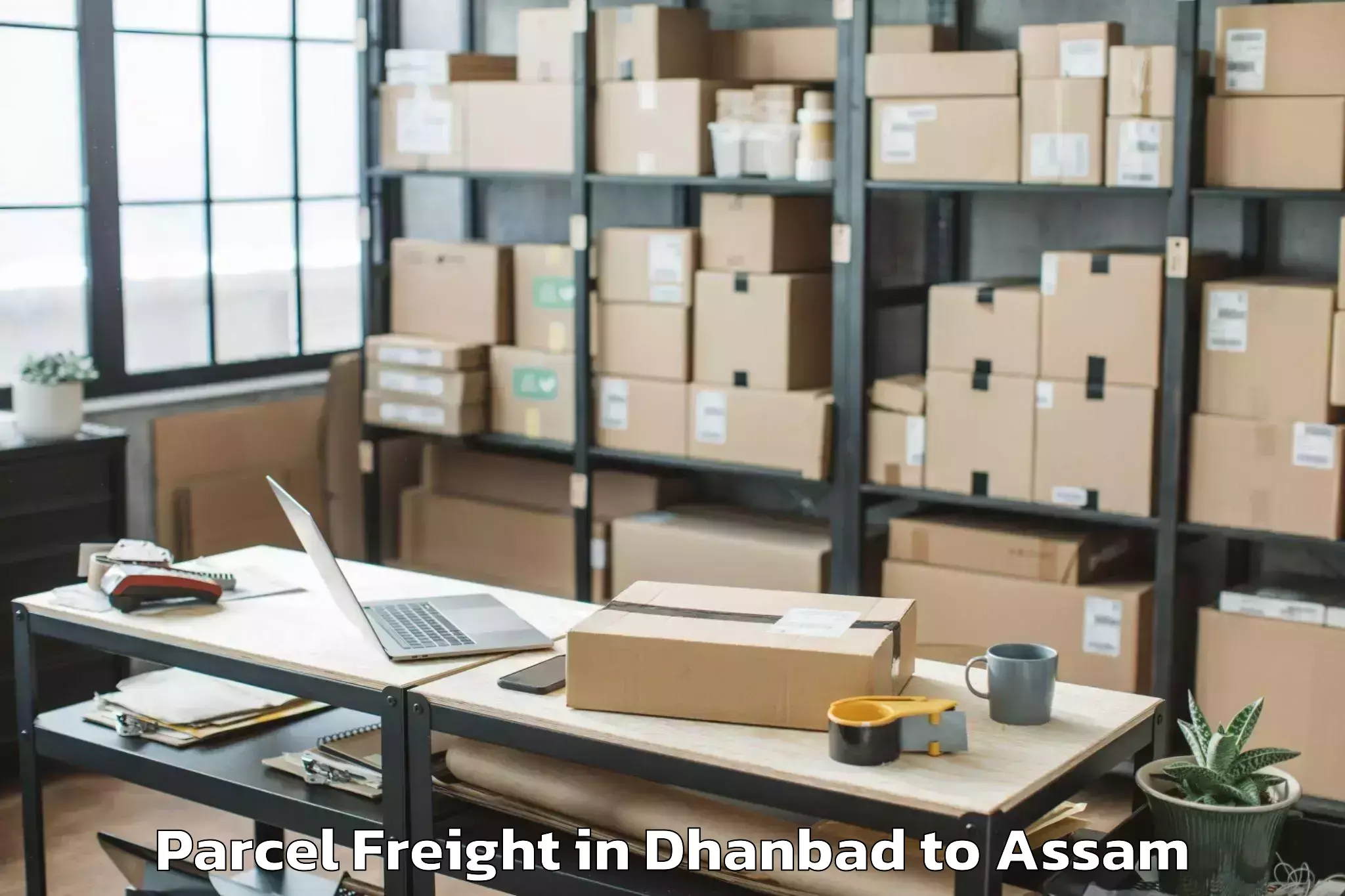 Book Your Dhanbad to Lilabari Airport Ixi Parcel Freight Today